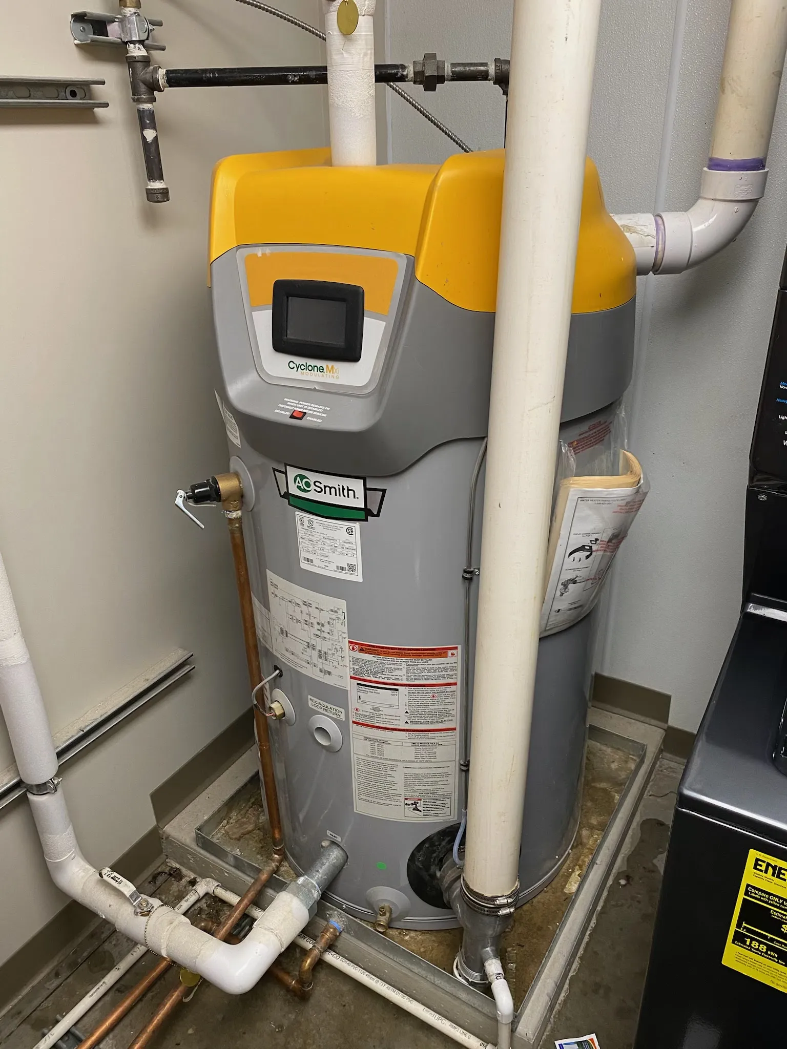 An A.O. Smith commercial water heater with copper piping in a mechanical room