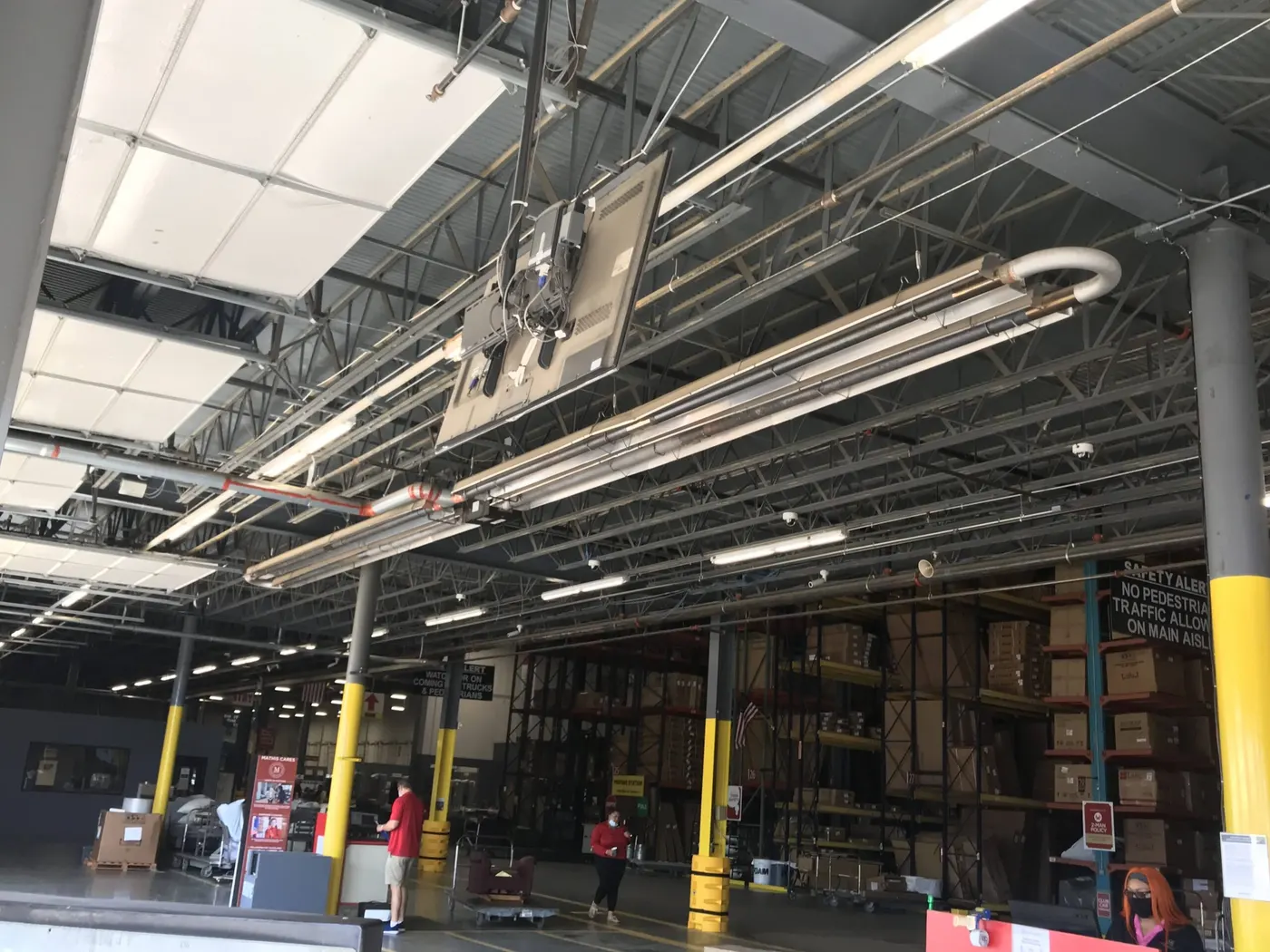 Gas piping run along the steel trusses of a large warehouse ceiling